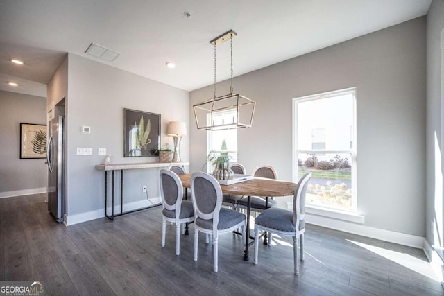 dining room with plenty of natural light and dark hardwood / wood-style floors