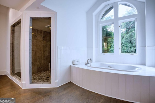 bathroom featuring hardwood / wood-style flooring and separate shower and tub