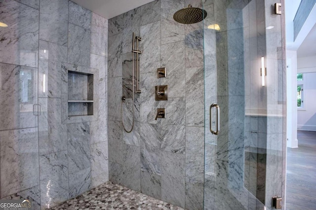 bathroom featuring wood-type flooring and walk in shower