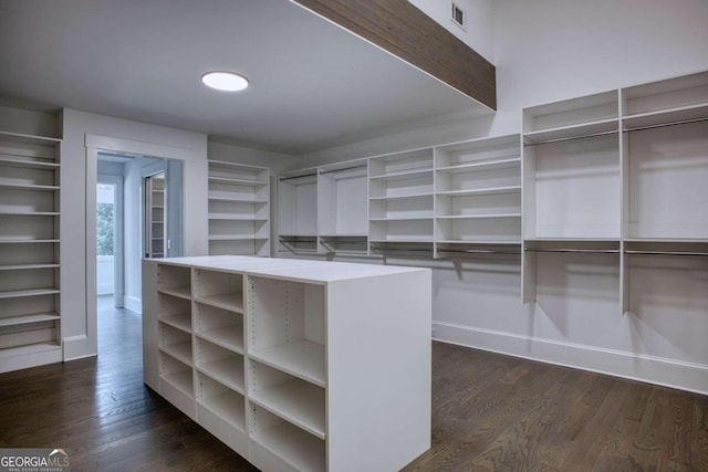 spacious closet with dark hardwood / wood-style floors