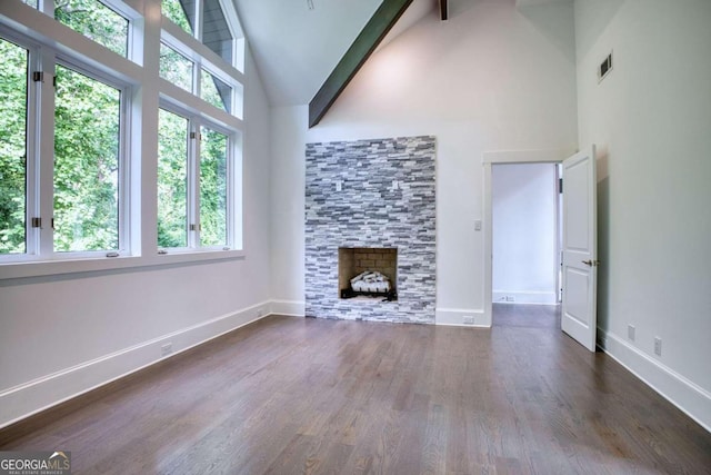 unfurnished living room with beam ceiling, a fireplace, dark hardwood / wood-style flooring, and high vaulted ceiling