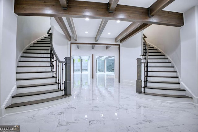 stairway featuring beam ceiling