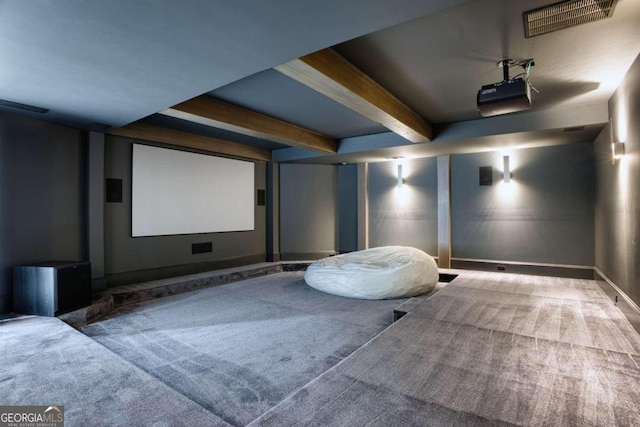 cinema with carpet flooring and beam ceiling