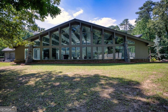 rear view of property with a lawn