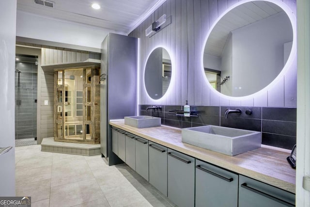 bathroom featuring tile patterned flooring, vanity, tile walls, and ornamental molding