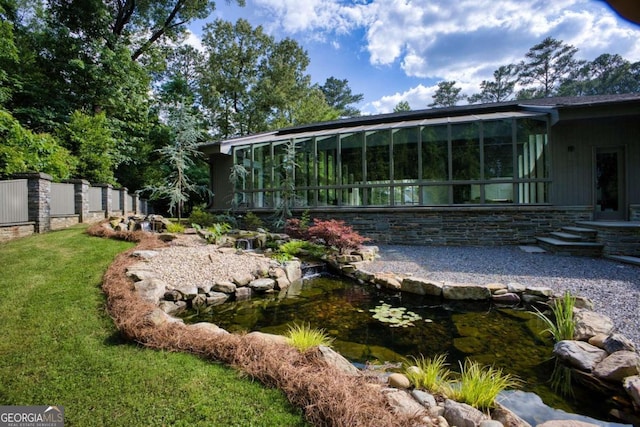 rear view of house with a garden pond