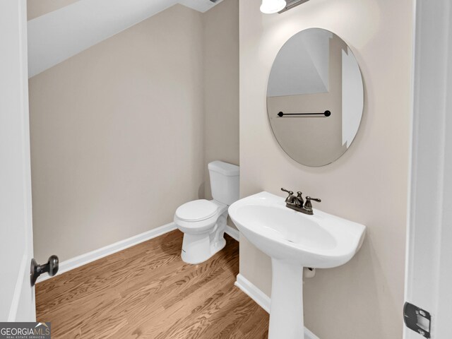 bathroom featuring hardwood / wood-style floors and toilet