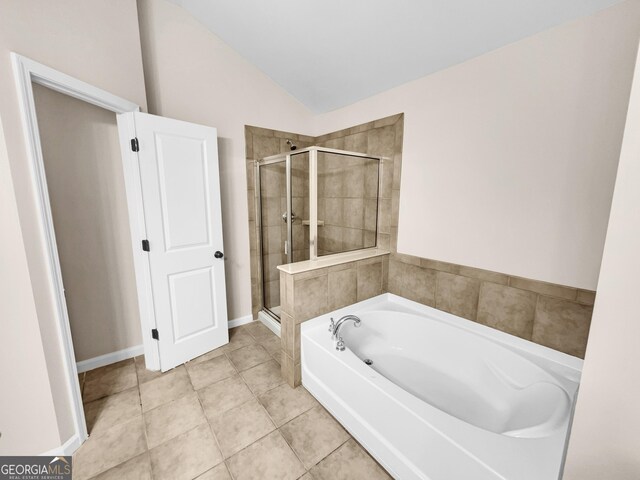 bathroom with separate shower and tub, tile patterned flooring, and vaulted ceiling