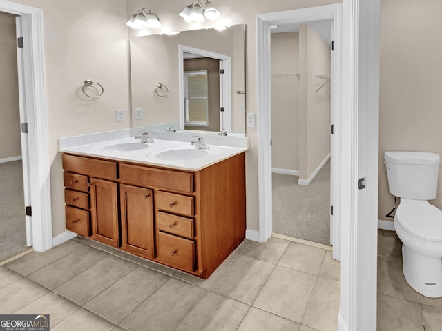 bathroom featuring tile patterned floors, vanity, and toilet