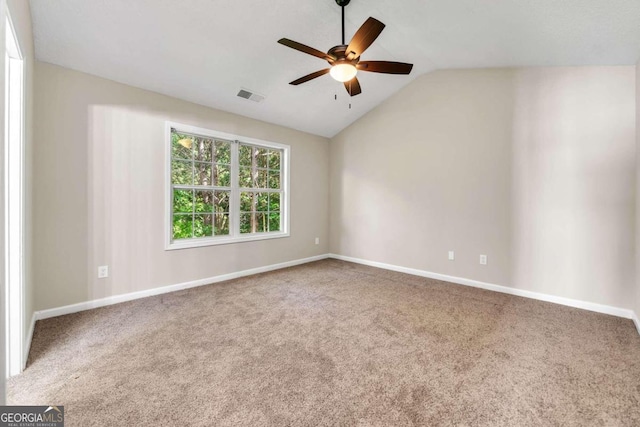 unfurnished room featuring carpet, vaulted ceiling, and ceiling fan