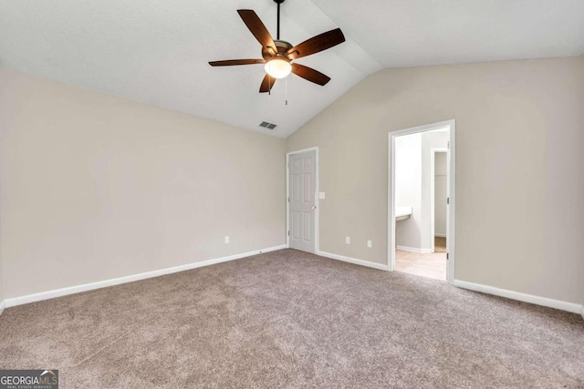 interior space with ceiling fan, lofted ceiling, and carpet floors