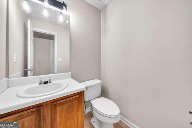 bathroom with tile patterned flooring, vanity, and toilet