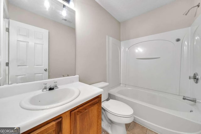 full bathroom with tile patterned floors,  shower combination, a textured ceiling, toilet, and vanity