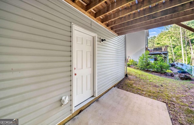 view of exterior entry featuring a patio area