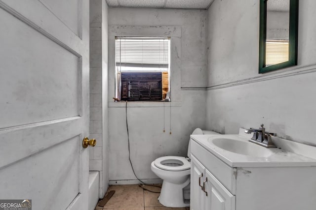 bathroom with cooling unit, a wealth of natural light, tile patterned flooring, and vanity