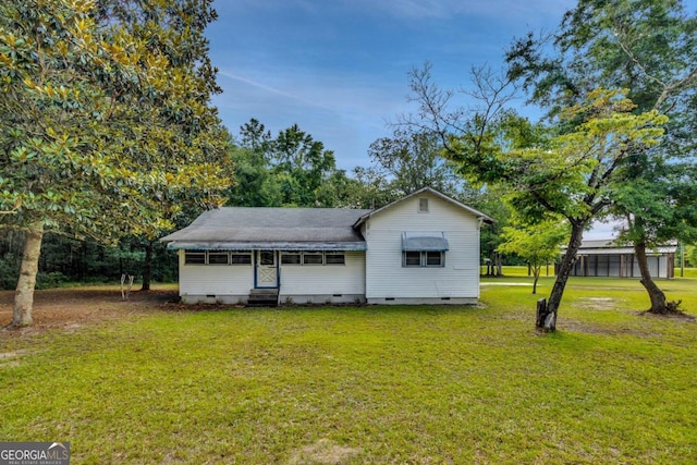 back of property featuring a yard