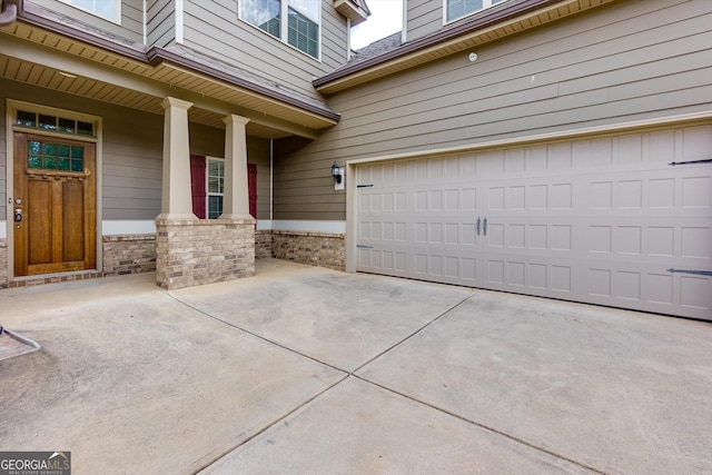 property entrance featuring a porch and a garage