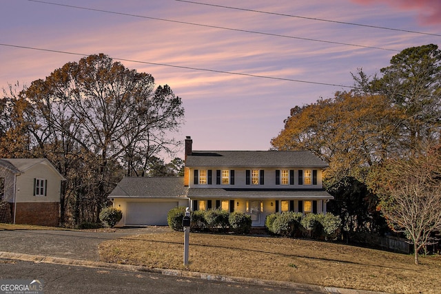 colonial inspired home featuring a garage