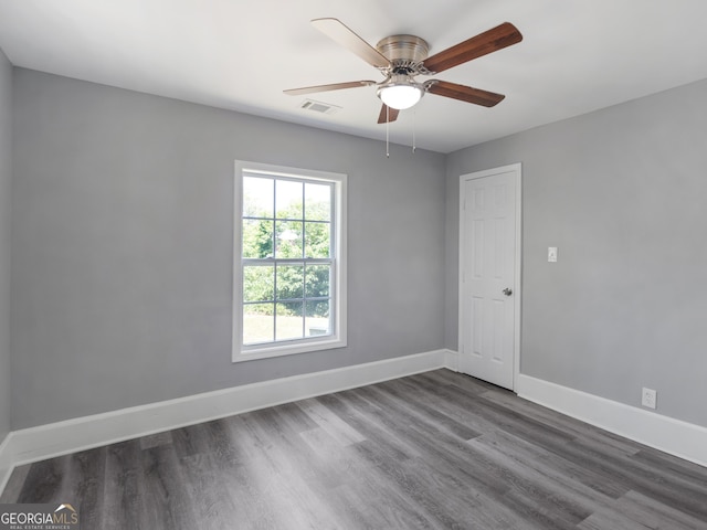 unfurnished room featuring ceiling fan and dark hardwood / wood-style flooring