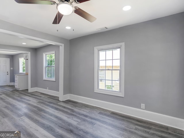 empty room featuring hardwood / wood-style flooring, ceiling fan, and a wealth of natural light