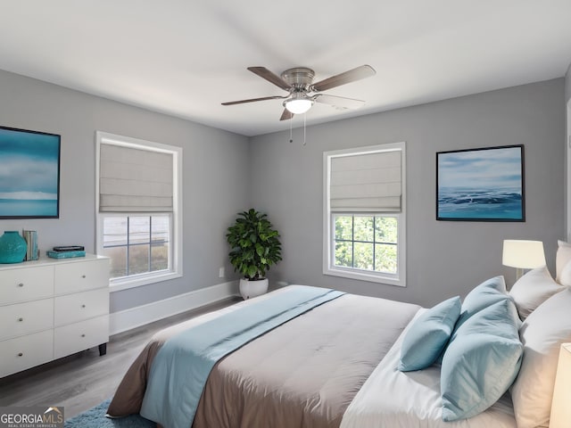 bedroom with ceiling fan and light hardwood / wood-style flooring