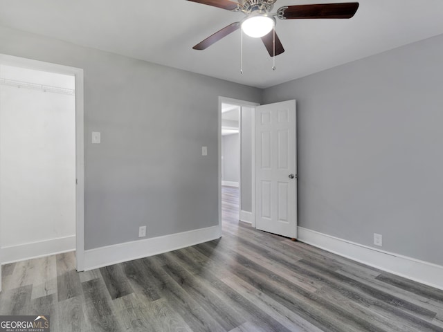 spare room featuring ceiling fan and dark hardwood / wood-style floors