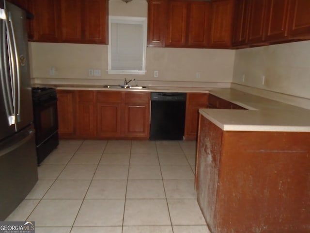 kitchen with kitchen peninsula, black appliances, sink, and light tile patterned floors