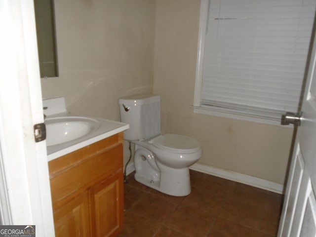 bathroom featuring tile patterned flooring, vanity, and toilet