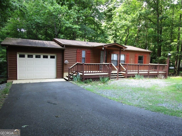 view of front of property with a deck and a garage