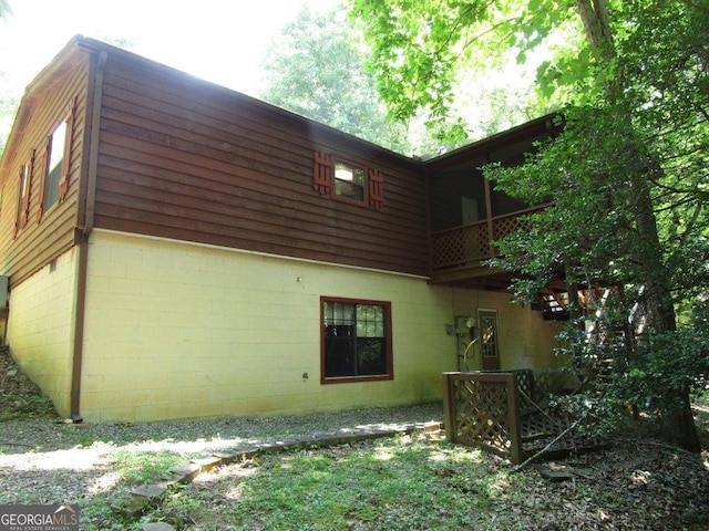 view of side of home featuring a balcony