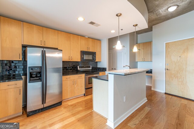 kitchen with hanging light fixtures, light hardwood / wood-style flooring, backsplash, light brown cabinetry, and appliances with stainless steel finishes