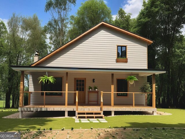 back of property with a lawn and covered porch