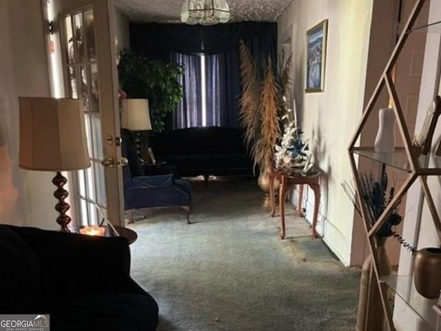 living area featuring carpet flooring and a chandelier