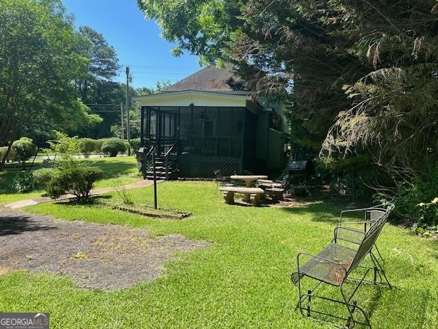 view of yard with a sunroom