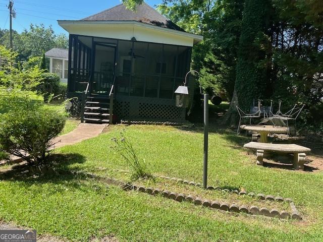 view of yard with a sunroom