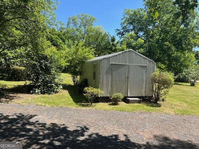 view of outdoor structure with a lawn