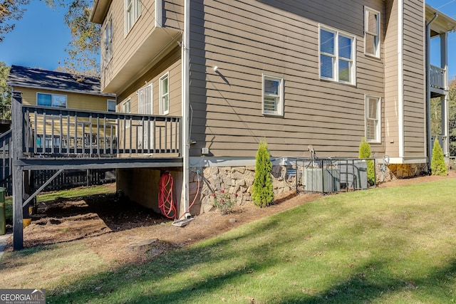 view of home's exterior featuring a lawn and a deck