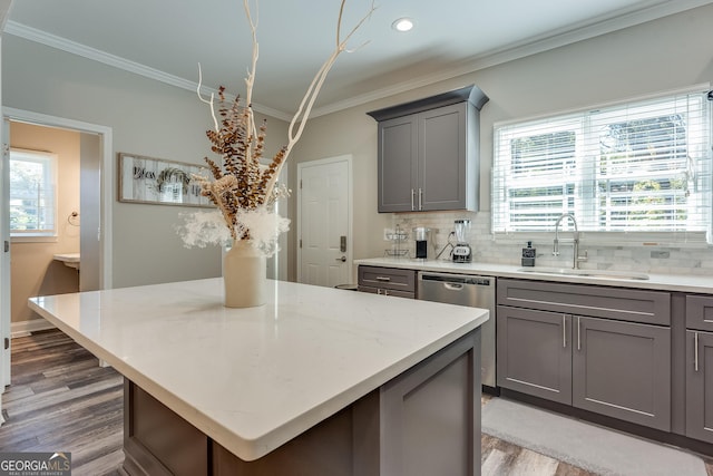 kitchen featuring gray cabinetry, sink, a center island, and stainless steel dishwasher