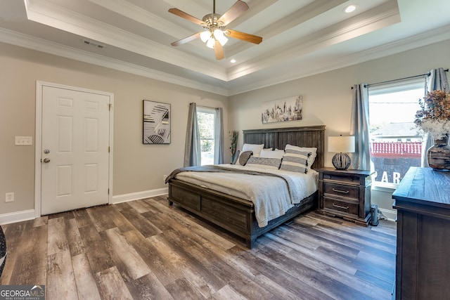 bedroom with a tray ceiling, ceiling fan, crown molding, and hardwood / wood-style flooring