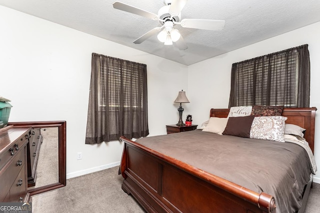bedroom featuring a textured ceiling, carpet, and ceiling fan