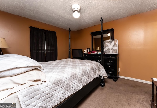 carpeted bedroom featuring a textured ceiling