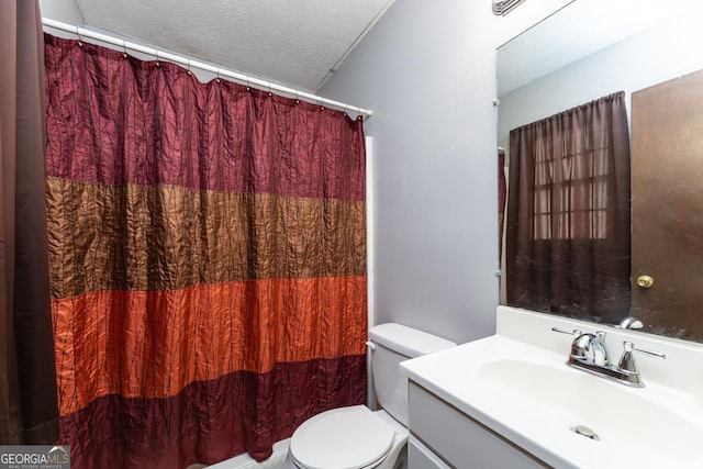bathroom featuring vanity, toilet, and a textured ceiling