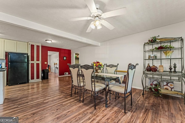 dining room featuring a textured ceiling and wood-type flooring