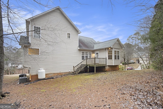 rear view of house with central air condition unit and a wooden deck