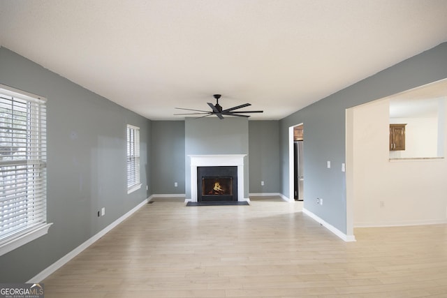 unfurnished living room with ceiling fan and light hardwood / wood-style floors