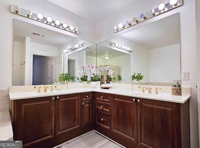 bathroom featuring double sink vanity and tile floors