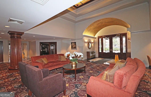 living room featuring french doors, ornamental molding, and decorative columns