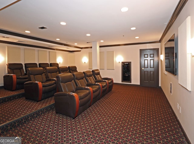 carpeted cinema room with crown molding