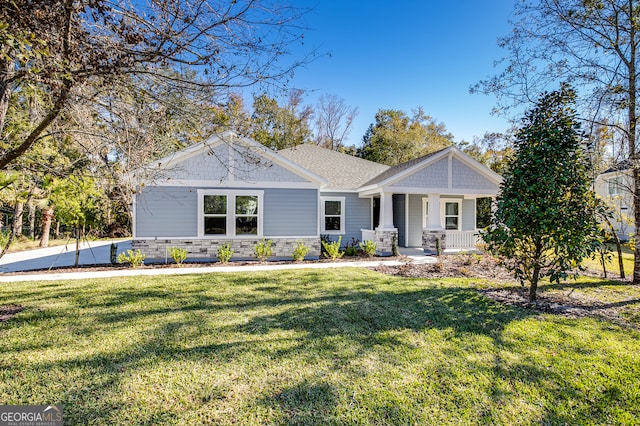 craftsman-style home featuring covered porch and a front lawn