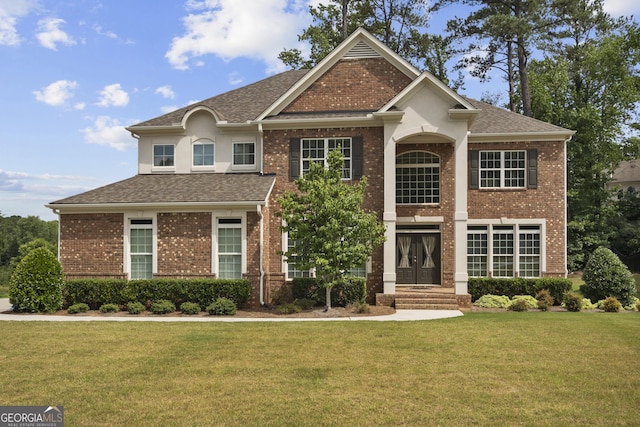 view of front facade with a front yard and french doors